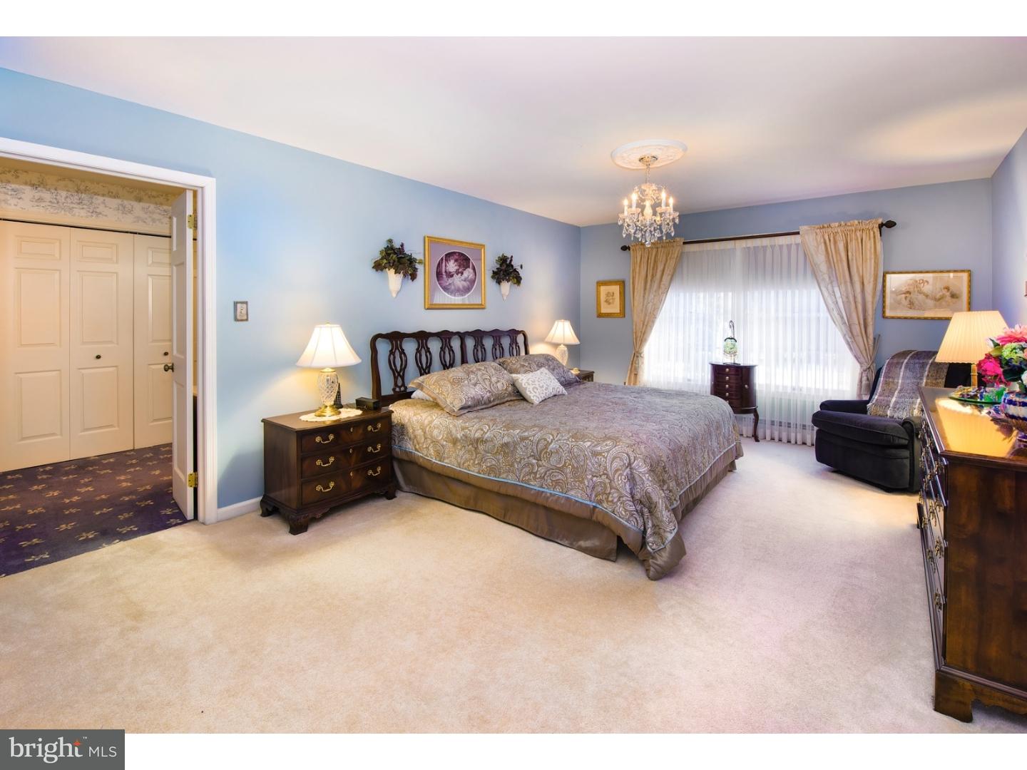 511 Old Gulph Road Penn Valley, PA 19072 - Photo 13 of 24 a bedroom with a bed next to a window with the dresser