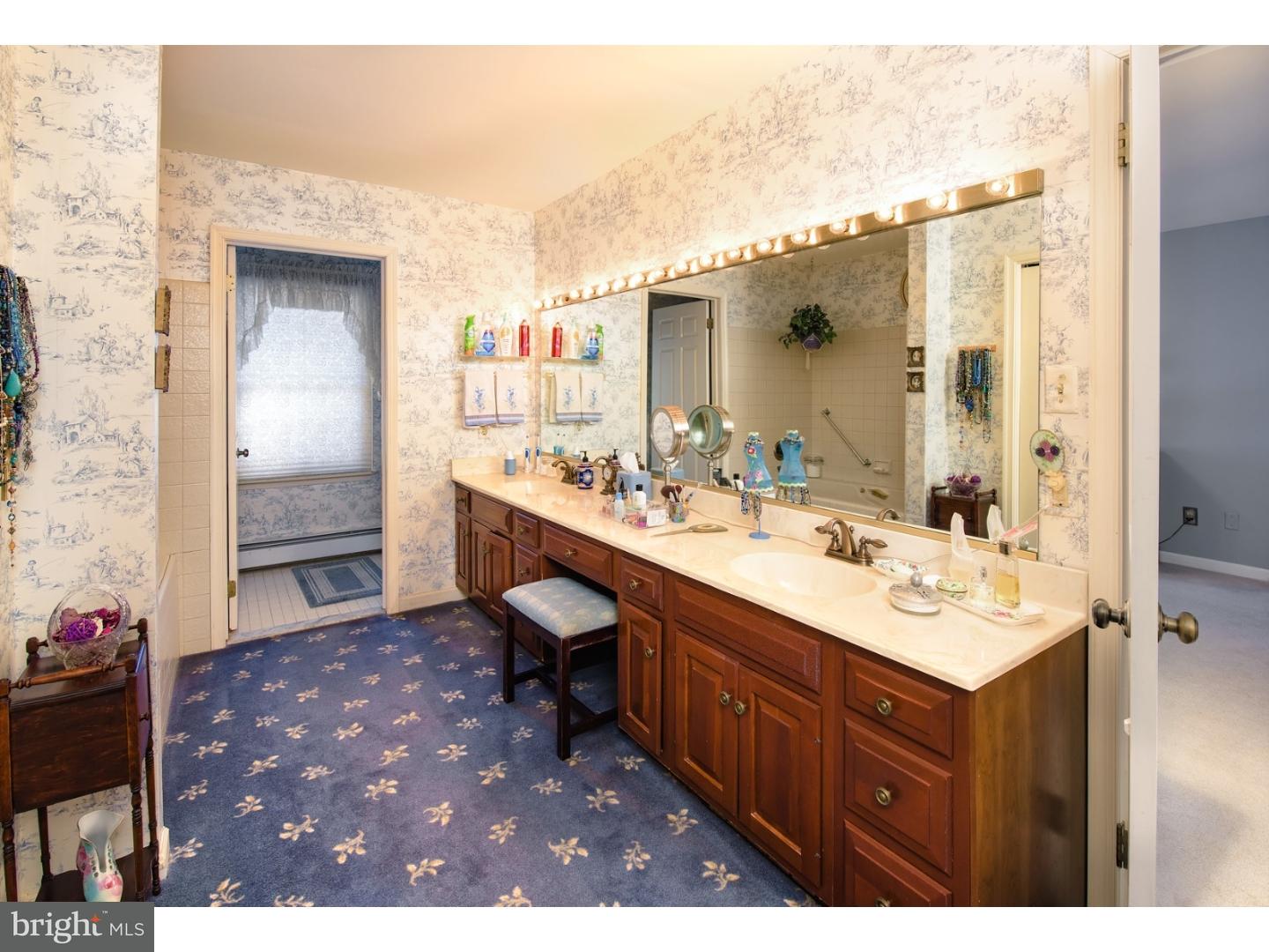 511 Old Gulph Road Penn Valley, PA 19072 - Photo 14 of 24 a bathroom with a sink a mirror and a shower