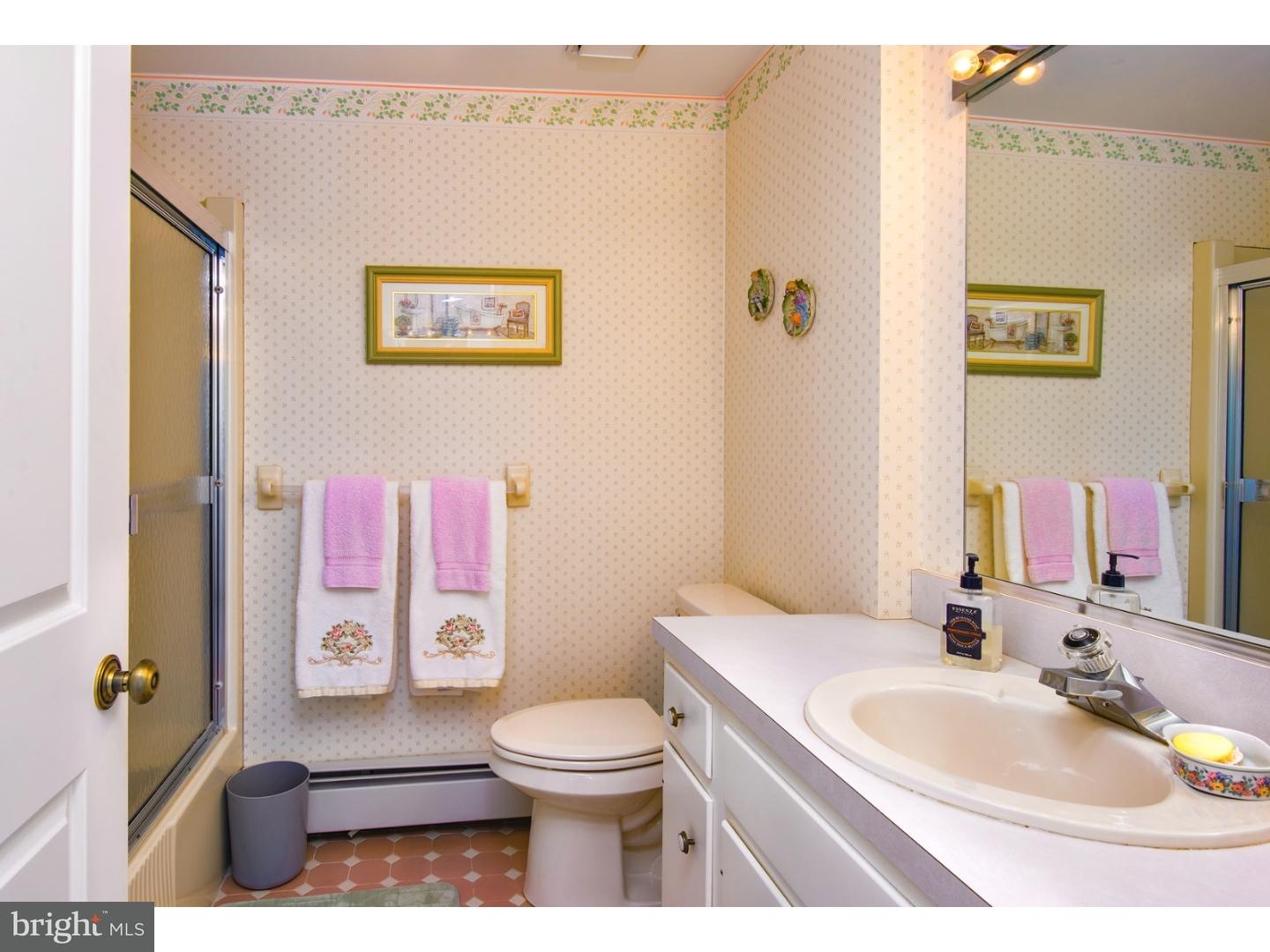511 Old Gulph Road Penn Valley, PA 19072 - Photo 17 of 24 a bathroom with a sink a toilet and shower curtain