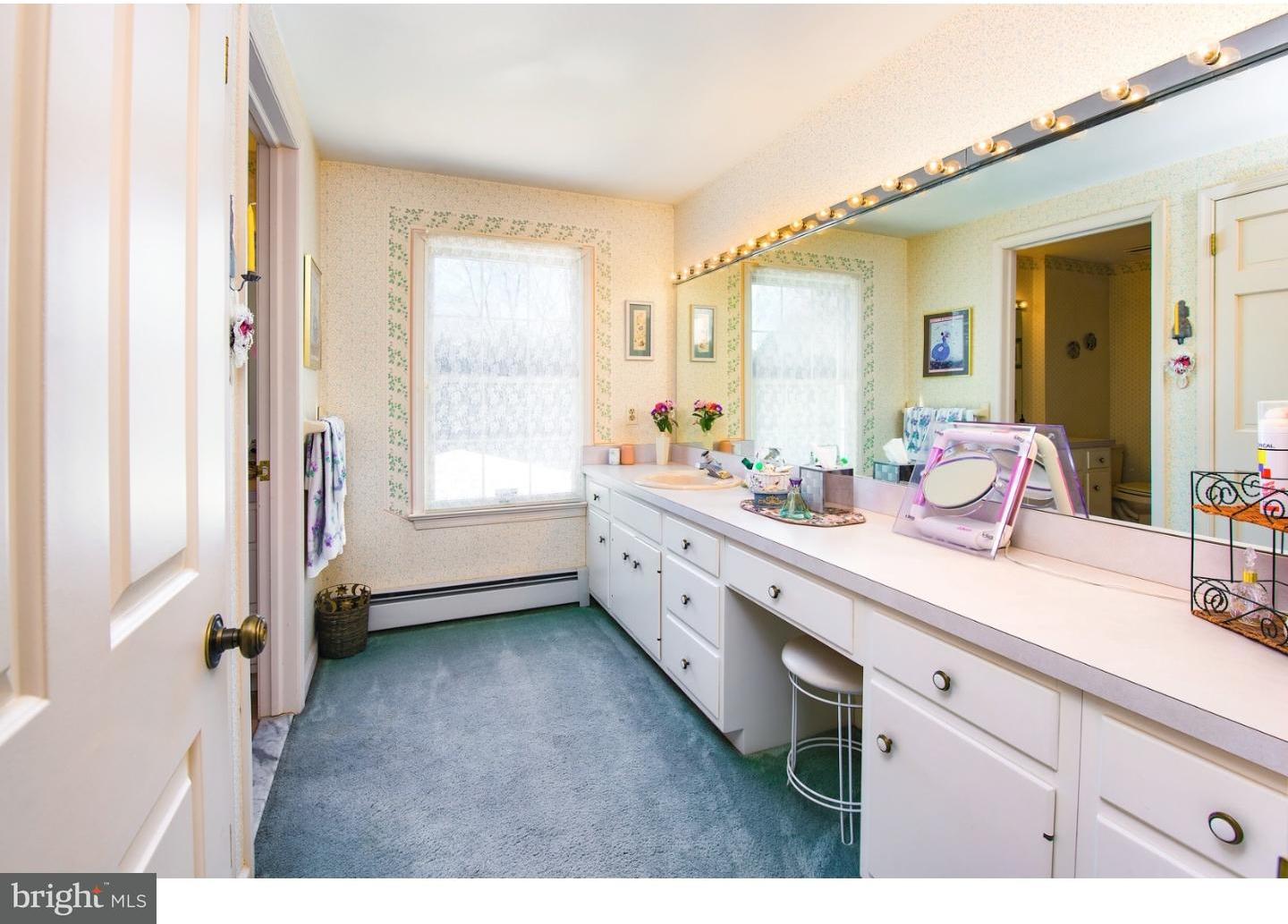 511 Old Gulph Road Penn Valley, PA 19072 - Photo 18 of 24 a spacious bathroom with a double vanity sink a mirror and a bathtub
