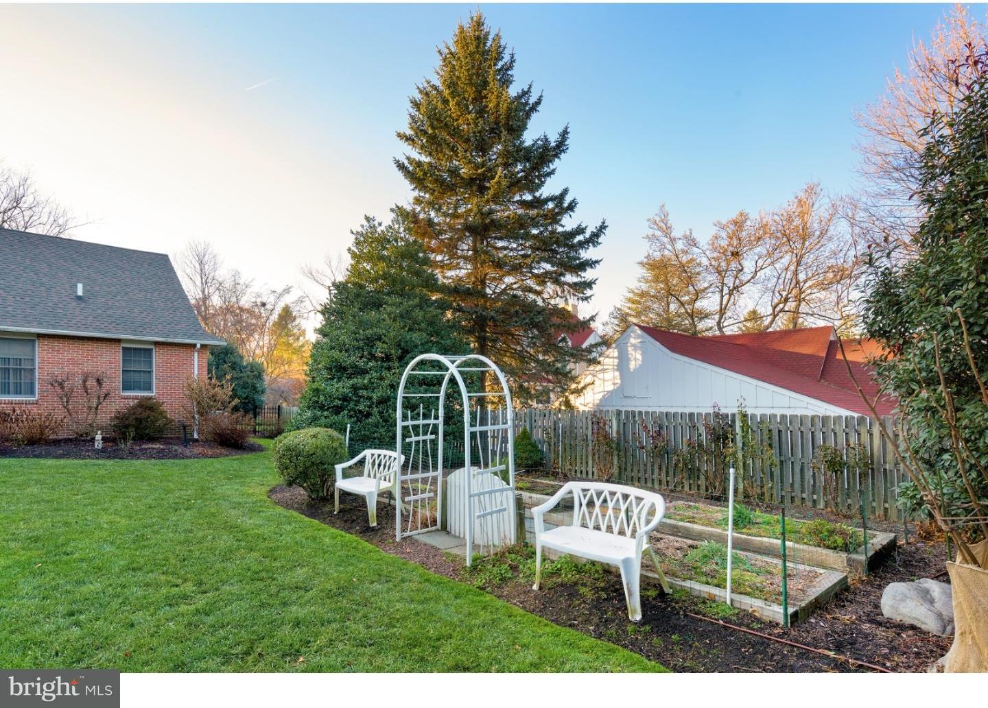 511 Old Gulph Road Penn Valley, PA 19072 - Photo 22 of 24 a view of a chair and table in backyard of the house