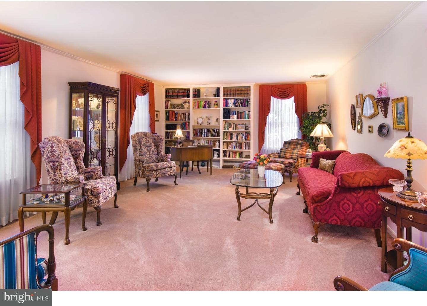 511 Old Gulph Road Penn Valley, PA 19072 - Photo 5 of 24 a living room with furniture a rug and a floor to ceiling window