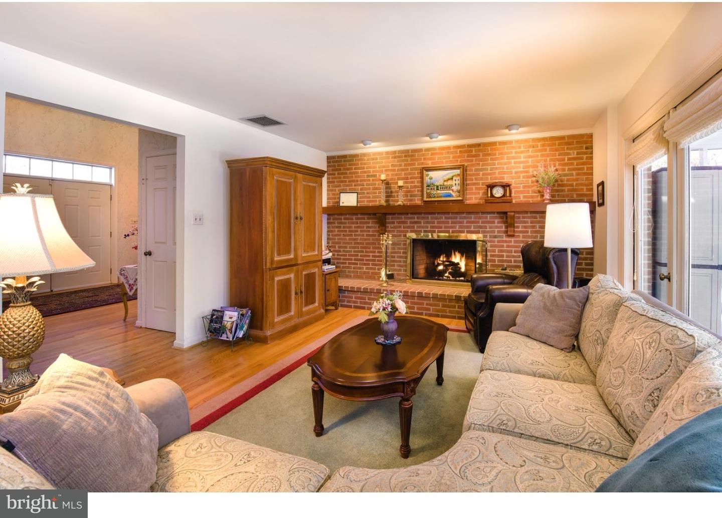 511 Old Gulph Road Penn Valley, PA 19072 - Photo 6 of 24 a living room with furniture a rug and a fireplace