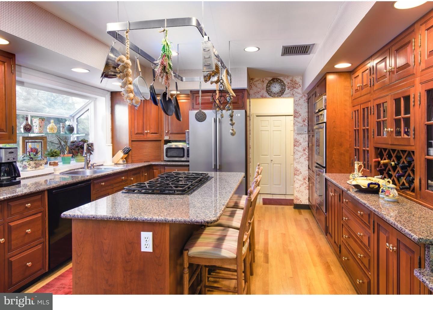 511 Old Gulph Road Penn Valley, PA 19072 - Photo 9 of 24 a kitchen with stainless steel appliances granite countertop a stove a sink dishwasher and a refrigerator