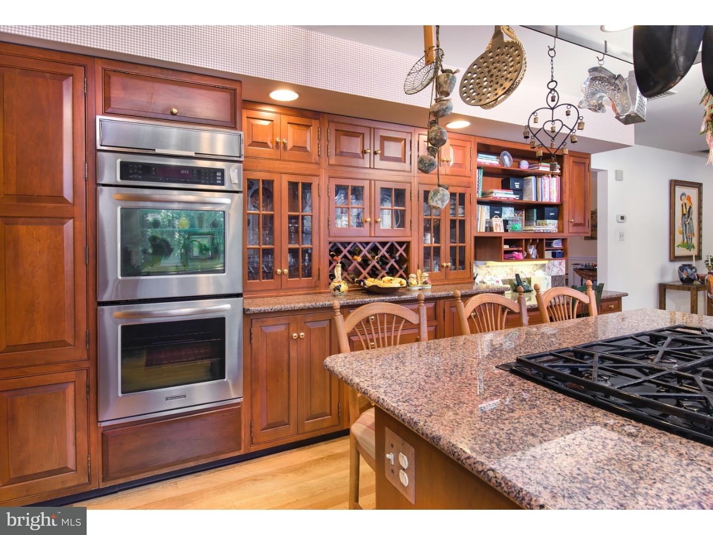 511 Old Gulph Road Penn Valley, PA 19072 - Photo 10 of 24 a kitchen view of a kitchen island a stove a microwave and a dining table