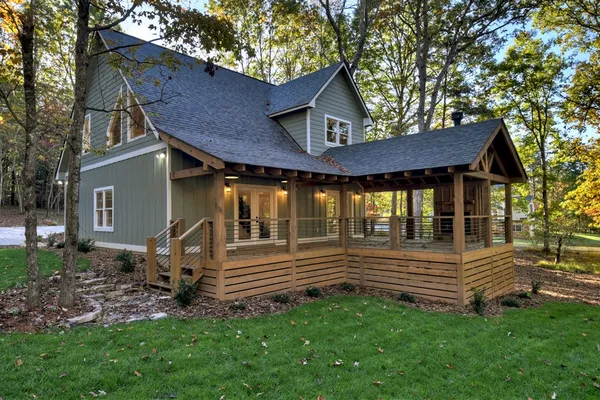 a view of a house with a yard and wooden fence