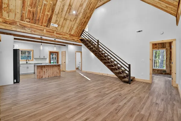 a view of an entryway with wooden floor