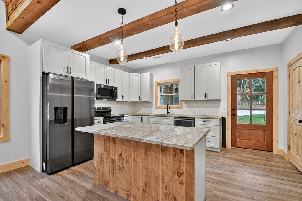 646 High Country Crossing Morganton, GA 30560 - Photo 22 of 44 a kitchen with stainless steel appliances granite countertop a refrigerator a sink dishwasher a stove and a refrigerator with wooden floor