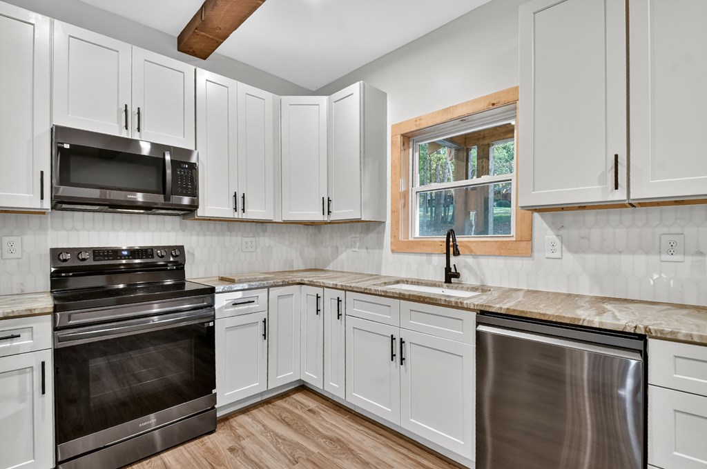 646 High Country Crossing Morganton, GA 30560 - Photo 23 of 44 a kitchen with cabinets stainless steel appliances a sink and a window