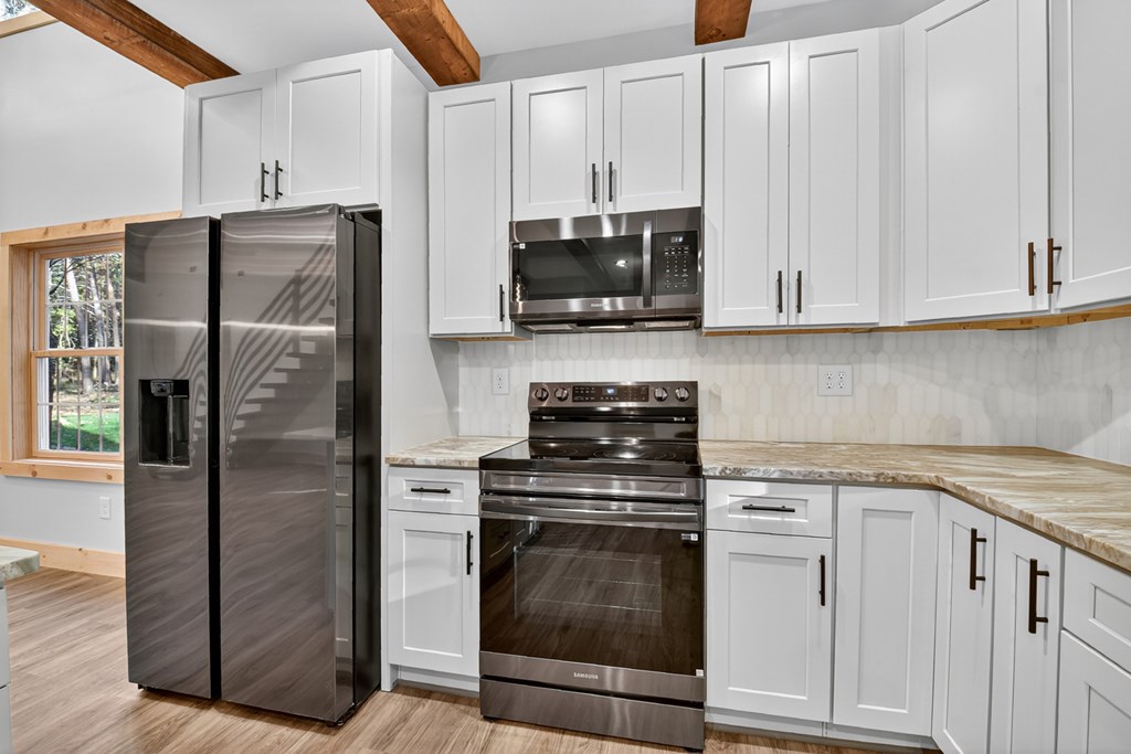 646 High Country Crossing Morganton, GA 30560 - Photo 24 of 44 a kitchen with stainless steel appliances granite countertop a stove a refrigerator and a sink