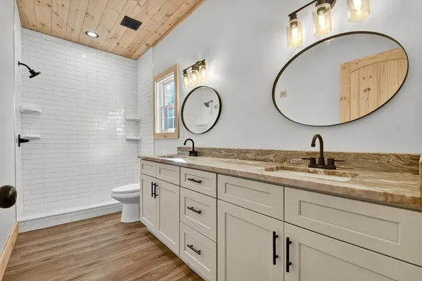 a bathroom with a double vanity sink and a mirror