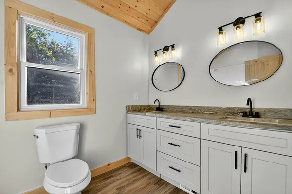 a bathroom with a toilet a sink and a mirror