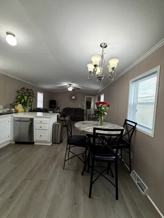a view of a dining room with furniture and chandelier