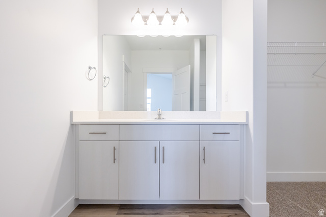 4664 South 680th West, Unit S301 Mapleton, UT 84664 - Photo 9 of 17 Contemporary vanity featuring a rectangular undermount sink, light-toned countertop, and chrome faucet