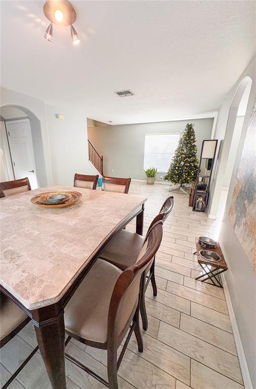 12715 Saulston Place Hudson, FL 34669 - Photo 12 of 44 a dinning table and chairs in a room