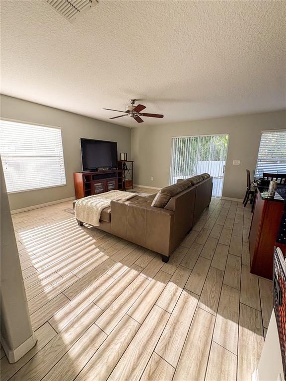 12715 Saulston Place Hudson, FL 34669 - Photo 13 of 44 a bedroom with furniture and a wooden floor