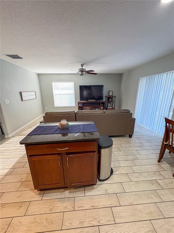 12715 Saulston Place Hudson, FL 34669 - Photo 16 of 44 a living room with a couch and a flat screen tv
