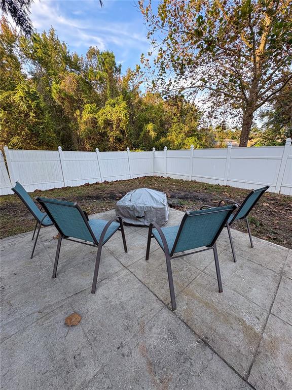 12715 Saulston Place Hudson, FL 34669 - Photo 18 of 44 a backyard of a house with table and chairs