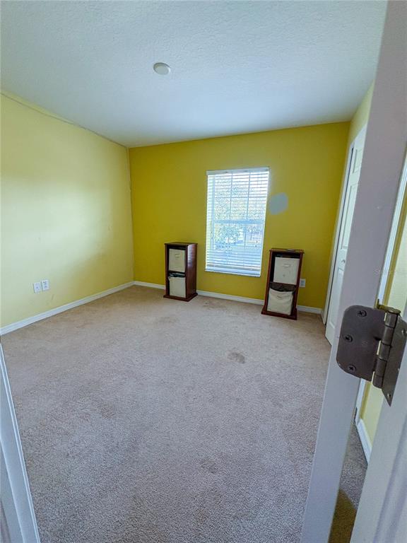12715 Saulston Place Hudson, FL 34669 - Photo 25 of 44 a view of an empty room with a window