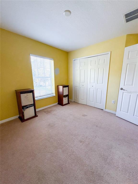 12715 Saulston Place Hudson, FL 34669 - Photo 26 of 44 a view of an empty room with a window