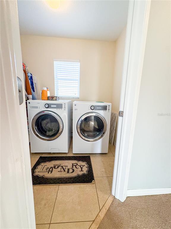 12715 Saulston Place Hudson, FL 34669 - Photo 27 of 44 a utility room with dryer and washer