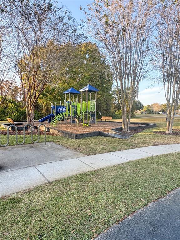 12715 Saulston Place Hudson, FL 34669 - Photo 43 of 44 a front view of a house with a yard
