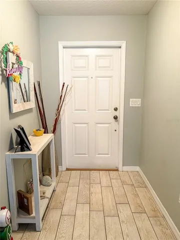 a view of an entryway with wooden floor