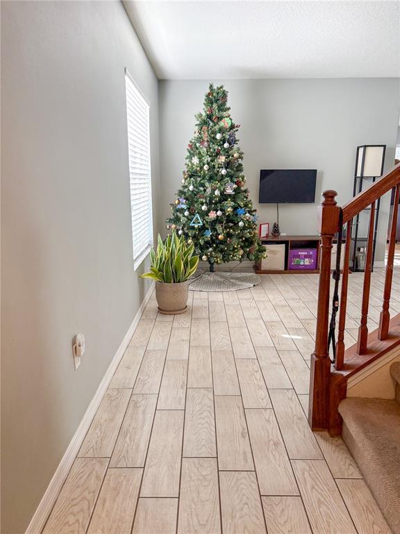 12715 Saulston Place Hudson, FL 34669 - Photo 7 of 44 a room with stairs and flowers