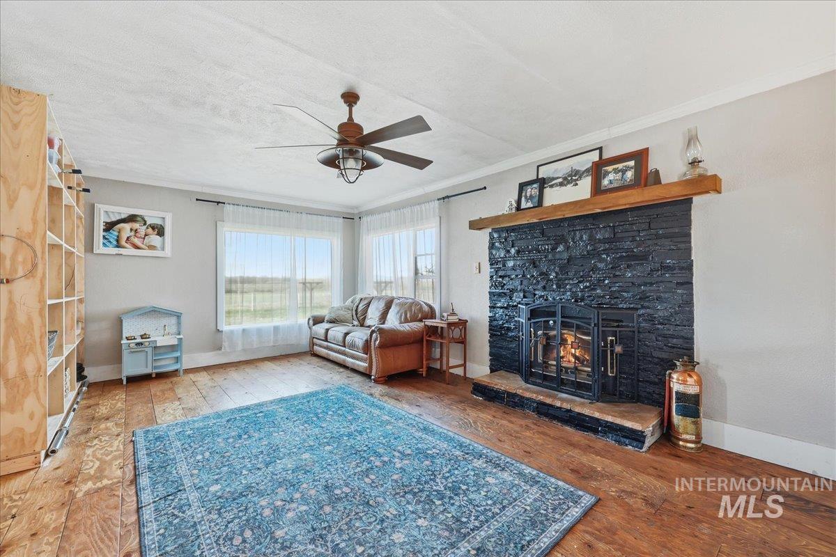 148 Glascock Road Weiser, ID 83672 - Photo 16 of 32 Living room with hardwood / wood-style floors, ornamental molding, ceiling fan, and a textured ceiling