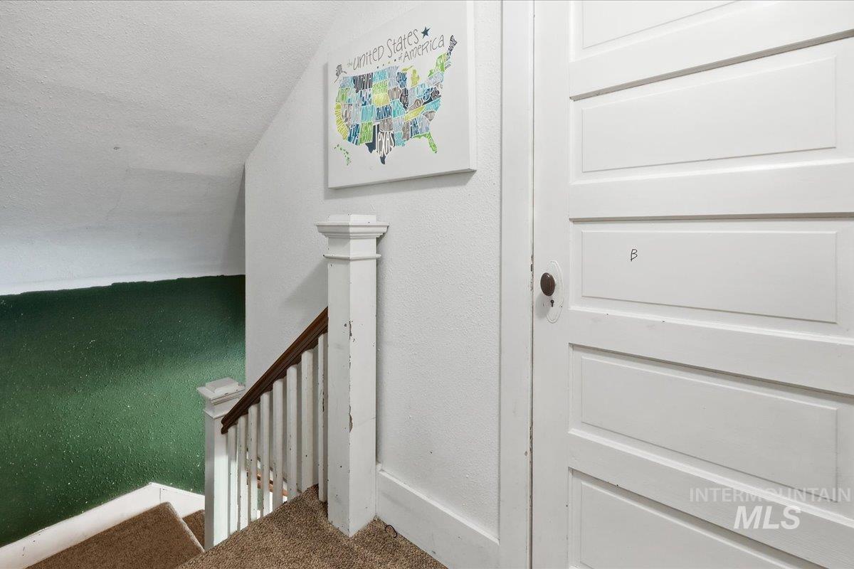 148 Glascock Road Weiser, ID 83672 - Photo 28 of 32 Stairway with carpet floors, a textured ceiling, and a textured wall