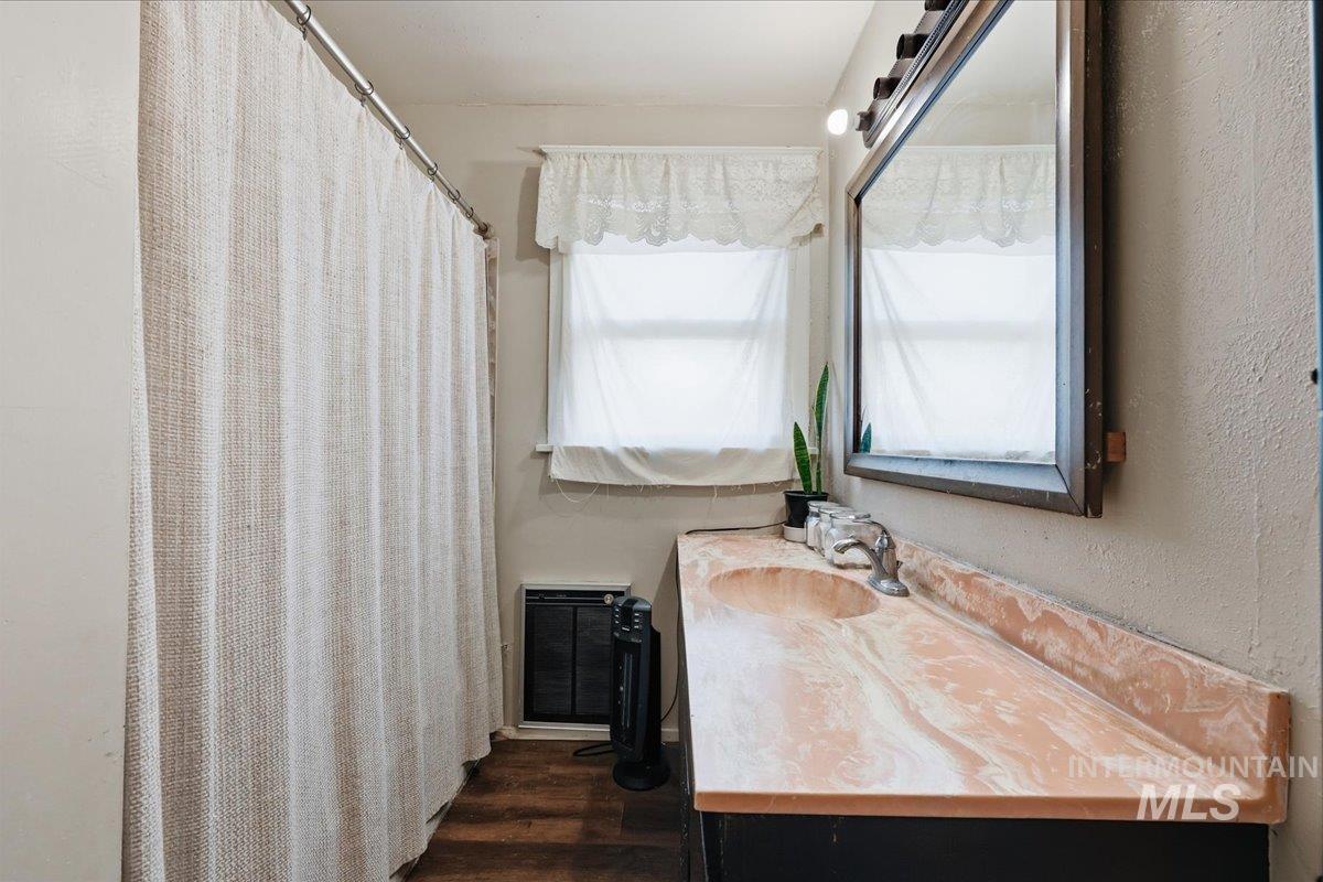 148 Glascock Road Weiser, ID 83672 - Photo 29 of 32 Bathroom featuring vanity, a shower with shower curtain, heating unit, and dark wood-style flooring