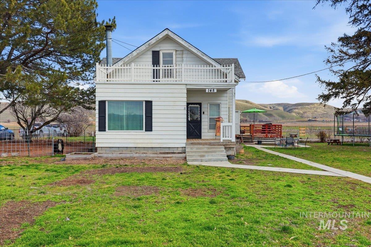 148 Glascock Road Weiser, ID 83672 - Photo 10 of 32 View of front of property with a mountain view, a trampoline, and a balcony