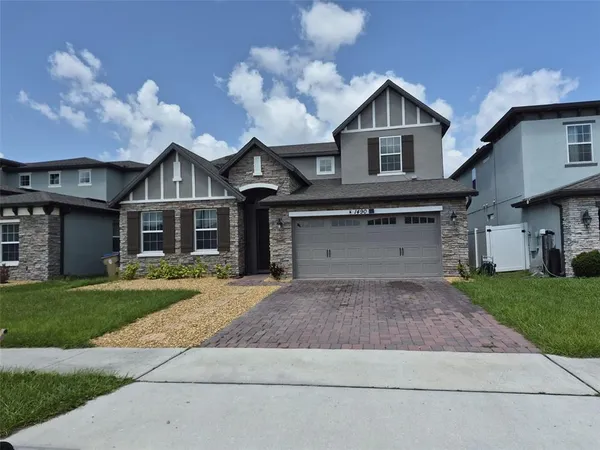 a front view of a house with a yard and a garage