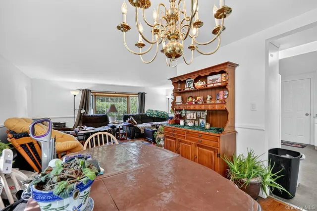 a living room with furniture a rug and a chandelier
