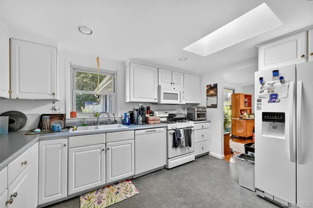 a kitchen with stainless steel appliances a refrigerator sink and cabinets