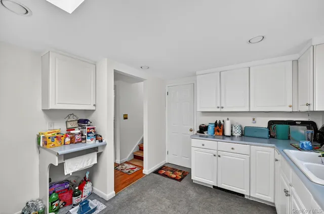 a kitchen with white cabinets and white appliances