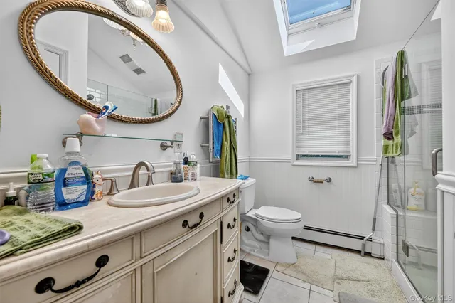 a bathroom with a sink a toilet and a mirror