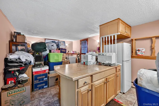a kitchen that has a lot of cabinets and refrigerator