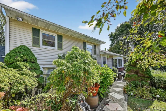 a front view of a house with a garden