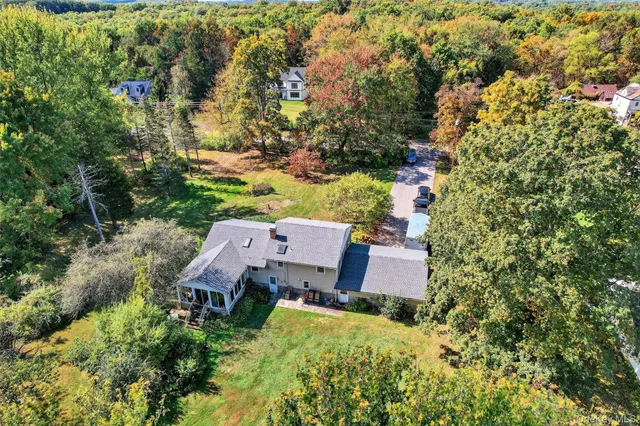 an aerial view of a houses with a yard