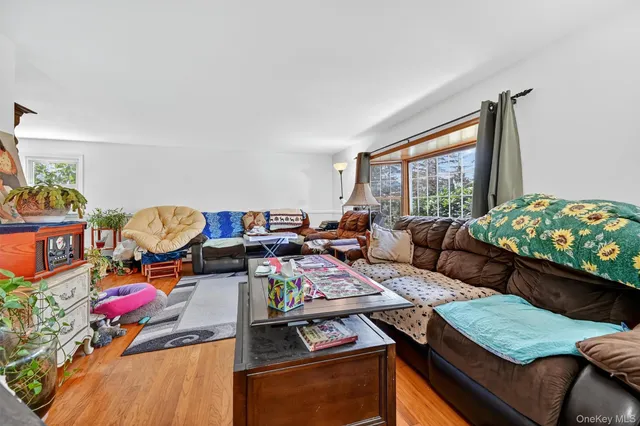 a living room with furniture and a floor to ceiling window