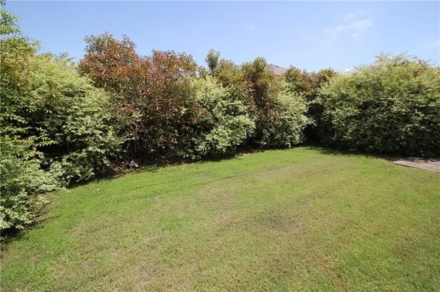 a view of a house with backyard and garden