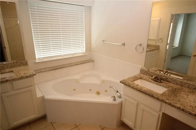 a bathroom with a bathtub sink and mirror
