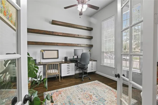 a living room with furniture a rug and a floor to ceiling window