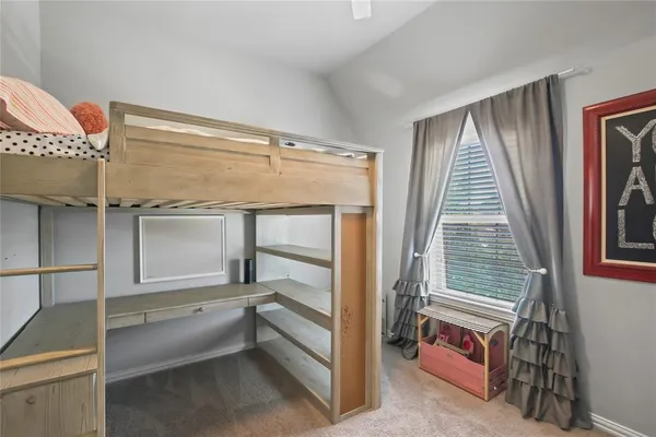 a view of an empty room with wooden floor and windows