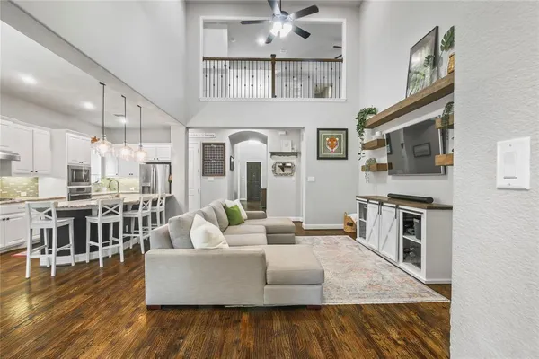 a living room with fireplace furniture and a wooden floor