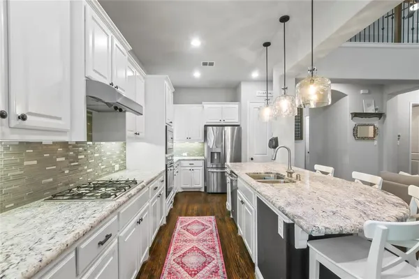 a kitchen with a stove sink and refrigerator