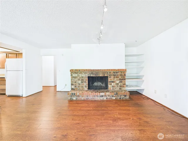 a view of kitchen and hall with wooden floor