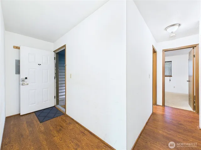 a view of a room with wooden floor