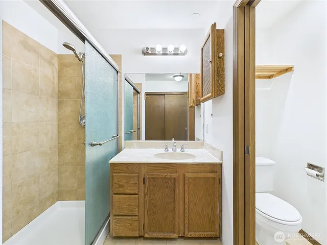 a bath room with a sink mirror and a bath tub